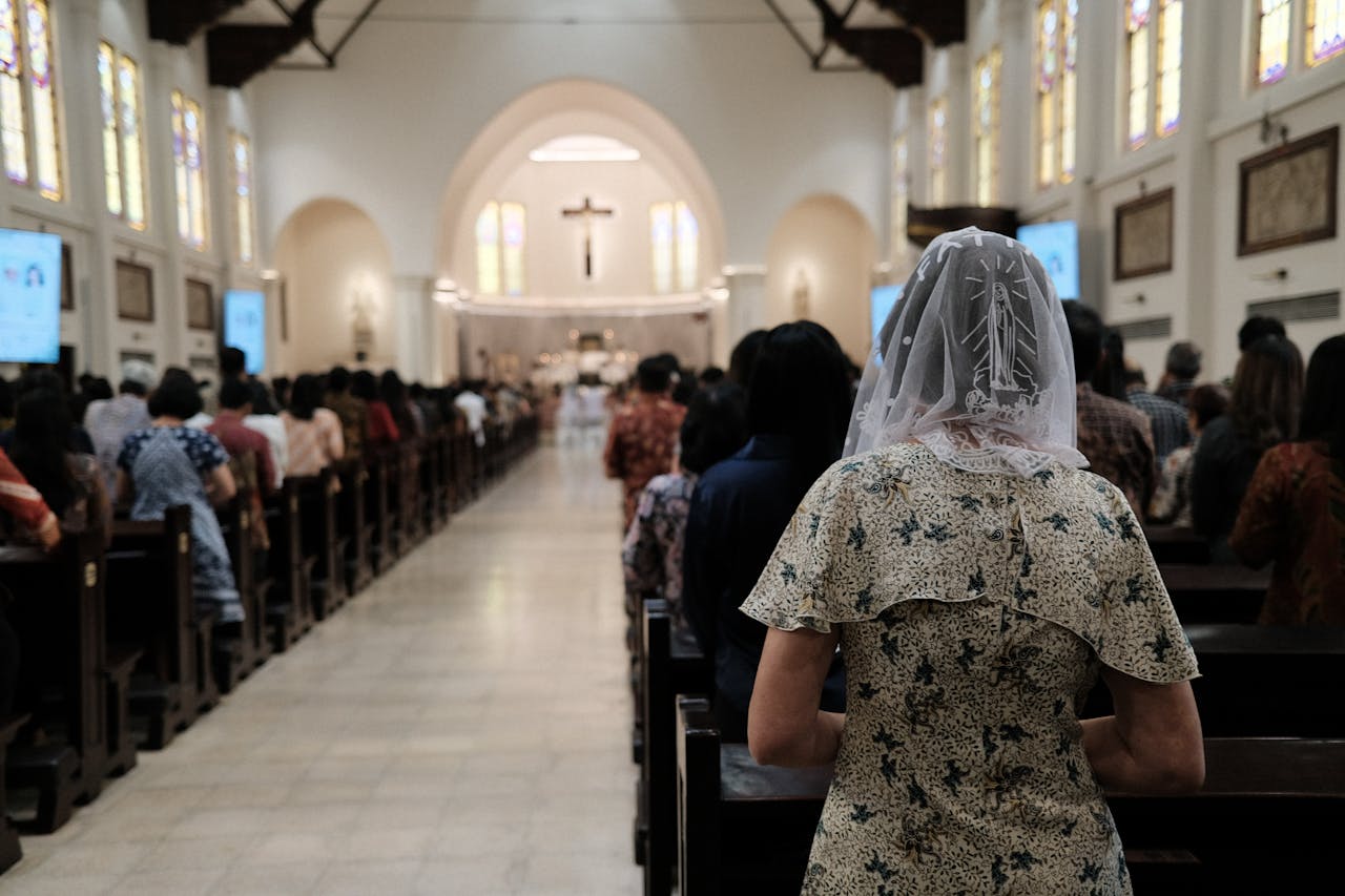 People gathered in an Indonesian church for a Mass service, showcasing community and faith.