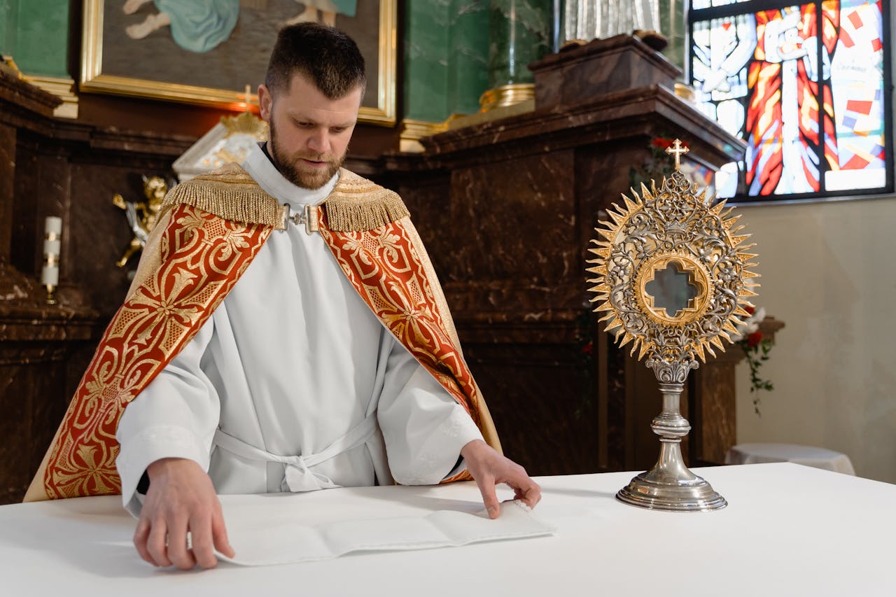 A priest preparing the altar with a monstrance in a Catholic church, highlighting sacred rituals.